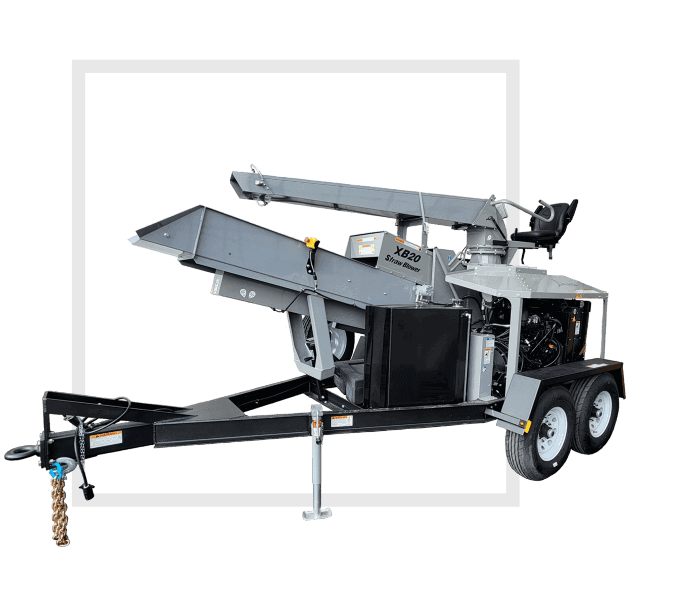Image of a straw blower. The straw blower sits ontop of a trailer with two wheels on either side. The straw blower is a light grey colour with two long rectangular pieces for receiving and blowing straw.
